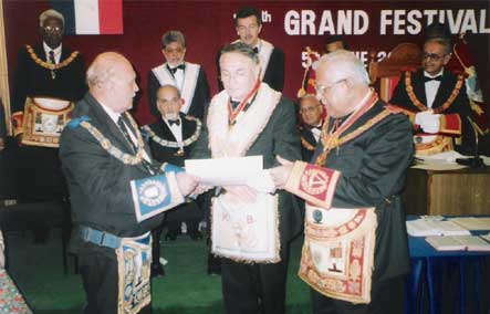"M.W.Bro. Yves Max Viton being presented the O.S.M. Jewel"