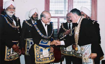 "M.W.Bro. Kapil Dev Joti and M.W.Bro. Yves Max Viton greet each other after signing the Treaty"